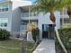 Building exterior showcasing gray siding, landscaping and entrance at 4410 Warren Ave # 203, Port Charlotte, FL 33953