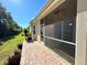 Screened patio with adjacent backyard and lush greenery at 10900 Lerwick Cir, Englewood, FL 34223