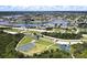 Aerial view of neighborhood with park, lake and tennis courts at 112 Sunnyside Nw St, Port Charlotte, FL 33952