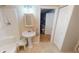 Small bathroom with pedestal sink, shower, and linen cabinet at 112 Sunnyside Nw St, Port Charlotte, FL 33952
