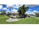 Single-story home with mature landscaping and a large grassy yard at 112 Sunnyside Nw St, Port Charlotte, FL 33952