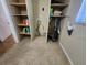 A functional laundry room with built-in shelving and tile floor at 112 Sunnyside Nw St, Port Charlotte, FL 33952