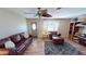 Spacious living room with hardwood floors, leather furniture, and ceiling fan at 112 Sunnyside Nw St, Port Charlotte, FL 33952