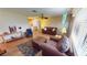 Living room with hardwood floors, leather furniture, and a view of the kitchen at 112 Sunnyside Nw St, Port Charlotte, FL 33952