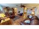 Living room with hardwood floors, leather furniture, and a view into the kitchen at 112 Sunnyside Nw St, Port Charlotte, FL 33952