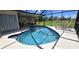 Inviting screened pool area with lounge chairs and patio furniture at 112 Sunnyside Nw St, Port Charlotte, FL 33952