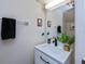 Small bathroom with white vanity, black faucet, and large mirror at 1216 Rio De Janeiro Ave # 306, Punta Gorda, FL 33983