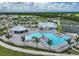 Aerial view of community pool, clubhouse, and tennis courts at 15023 Black Cherry Way, Punta Gorda, FL 33955