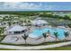 Aerial view of community pool, clubhouse, and tennis courts at 15023 Black Cherry Way, Punta Gorda, FL 33955