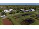 Drone view of property featuring unique dome houses and outbuildings at 15871 Huffmaster Rd, North Fort Myers, FL 33917