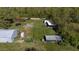 Aerial view of property with various outbuildings and fenced areas at 15871 Huffmaster Rd, North Fort Myers, FL 33917