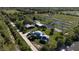 Aerial view of property showing home, outbuildings, and extensive land at 15871 Huffmaster Rd, North Fort Myers, FL 33917