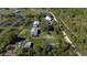 Aerial view of property showcasing multiple buildings and surrounding land at 15871 Huffmaster Rd, North Fort Myers, FL 33917