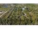 Aerial view showing a large property with ponds and vegetation at 15871 Huffmaster Rd, North Fort Myers, FL 33917