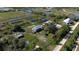 Aerial view highlighting buildings, ponds and surrounding landscape at 15871 Huffmaster Rd, North Fort Myers, FL 33917
