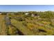 Aerial view of property with a large lot and surrounding wetlands at 15871 Huffmaster Rd, North Fort Myers, FL 33917
