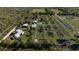 Aerial view showing home, pond, and surrounding land at 15871 Huffmaster Rd, North Fort Myers, FL 33917