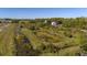 Aerial view of property showcasing a large lot and surrounding wetlands at 15871 Huffmaster Rd, North Fort Myers, FL 33917