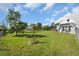 Landscaped backyard with grassy areas and trees at 15871 Huffmaster Rd, North Fort Myers, FL 33917