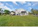 Another view of the home's unique design and yard at 15871 Huffmaster Rd, North Fort Myers, FL 33917