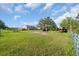 Spacious grassy yard with shed and fenced area at 15871 Huffmaster Rd, North Fort Myers, FL 33917