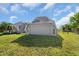 Attached garage with a gray door and windows at 15871 Huffmaster Rd, North Fort Myers, FL 33917