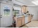 Charming kitchen with stained-glass door and light cabinets at 15871 Huffmaster Rd, North Fort Myers, FL 33917