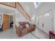 Living area featuring a brown couch and entryway at 15871 Huffmaster Rd, North Fort Myers, FL 33917