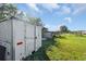 White storage building in a grassy backyard at 15871 Huffmaster Rd, North Fort Myers, FL 33917