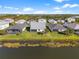 Aerial view of homes near lake with lush landscape at 16224 Laurel Oak Ln, Punta Gorda, FL 33982