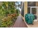 Deck and tropical landscaping with covered grill at 1636 Palace Ct, Port Charlotte, FL 33980
