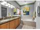 Bathroom with double vanity and soaking tub at 1636 Palace Ct, Port Charlotte, FL 33980