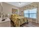 Bright bedroom with leafy patterned bedding and wood-look floors at 1636 Palace Ct, Port Charlotte, FL 33980