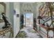 Bright and airy entryway with tiled floor, tropical decor and access to the backyard at 1636 Palace Ct, Port Charlotte, FL 33980
