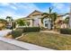 Attractive curb appeal with well-manicured lawn, tropical plants and a two-car garage at 1636 Palace Ct, Port Charlotte, FL 33980