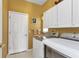 Laundry room with washer, dryer, and ample cabinet space at 1636 Palace Ct, Port Charlotte, FL 33980