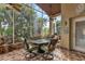 Relaxing screened porch with a patio table and chairs, perfect for outdoor dining at 1636 Palace Ct, Port Charlotte, FL 33980