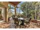 Spacious screened porch with tile flooring and comfortable seating, overlooking the backyard at 1636 Palace Ct, Port Charlotte, FL 33980