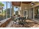 Screened porch with ample seating and a view of the surrounding neighborhood at 1636 Palace Ct, Port Charlotte, FL 33980