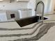 Close-up of a kitchen sink with modern faucet and quartz countertop at 16380 Cape Horn Blvd, Punta Gorda, FL 33955