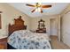 Charming bedroom with antique wooden bed frame and ceiling fan at 17032 Ohara Dr, Port Charlotte, FL 33948