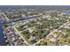 An aerial view of a residential neighborhood, showcasing various homes and the surrounding landscape at 18514 Goodman Cir, Port Charlotte, FL 33948