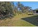 Private backyard with lush vegetation and open space at 18514 Goodman Cir, Port Charlotte, FL 33948