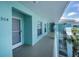 Condo hallway with light teal walls and gray door at 19385 Water Oak Dr # 304, Port Charlotte, FL 33948