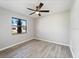 Well-lit bedroom featuring a large window and ceiling fan at 21047 Baffin Ave, Port Charlotte, FL 33954