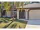 House exterior featuring a garage and palm trees at 21047 Baffin Ave, Port Charlotte, FL 33954