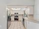 Galley kitchen with stainless steel appliances and light cabinets at 21047 Baffin Ave, Port Charlotte, FL 33954