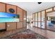 Stylish living room featuring wood paneling, a flat-screen TV, an area rug, and access to the outdoor patio at 23 Tiffany St, Englewood, FL 34223