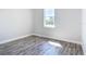 Small bedroom with a window and gray vinyl plank flooring at 2370 Irondale Rd, North Port, FL 34287