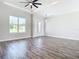 Open living room with hardwood floors and an electric fireplace at 2370 Irondale Rd, North Port, FL 34287